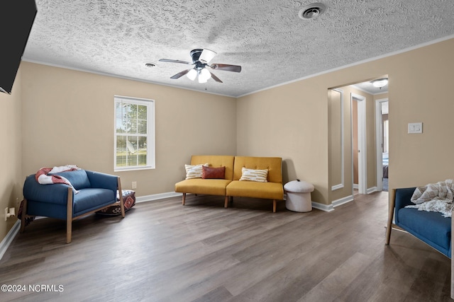 living area with hardwood / wood-style flooring, crown molding, ceiling fan, and a textured ceiling