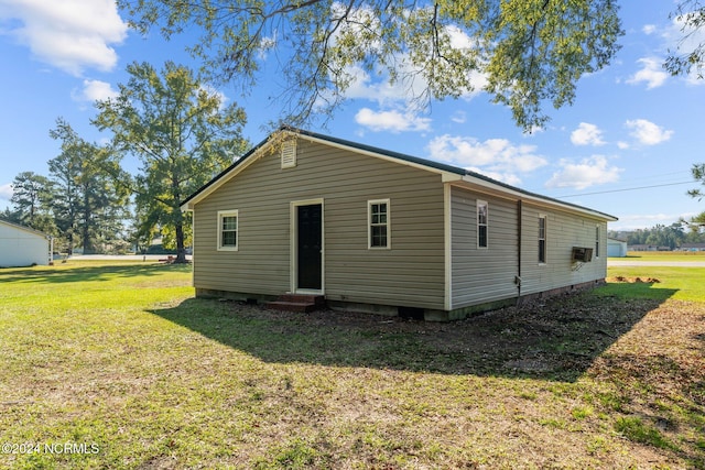 rear view of property with a yard