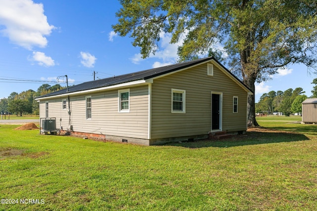 view of property exterior with cooling unit and a yard