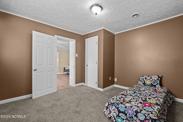 unfurnished bedroom with crown molding, carpet flooring, and a textured ceiling