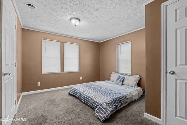 bedroom with ornamental molding, carpet, and a textured ceiling