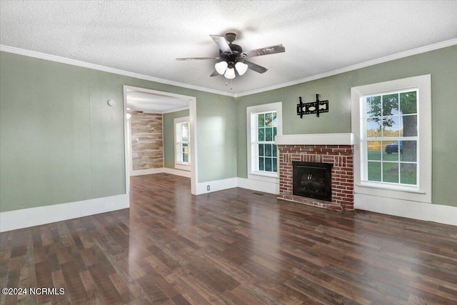 unfurnished living room with dark wood-type flooring, a textured ceiling, a wealth of natural light, and a fireplace