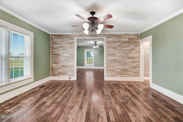 spare room featuring ornamental molding, ceiling fan, a textured ceiling, and dark hardwood / wood-style flooring