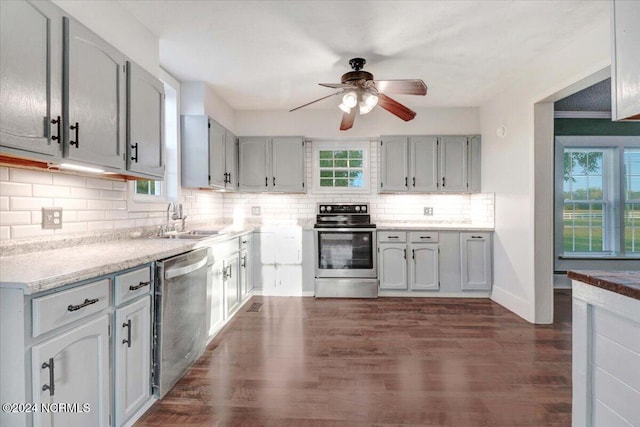 kitchen featuring sink, appliances with stainless steel finishes, dark hardwood / wood-style floors, and plenty of natural light