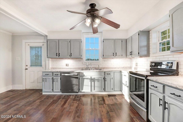 kitchen featuring appliances with stainless steel finishes, decorative backsplash, dark hardwood / wood-style floors, and sink