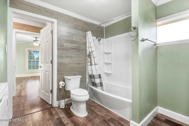 full bathroom with wood-type flooring, shower / tub combo with curtain, toilet, ceiling fan, and crown molding