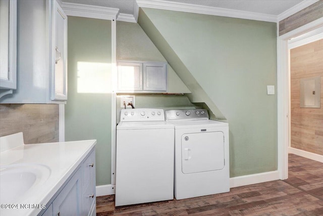 laundry room featuring dark wood-type flooring, crown molding, washing machine and dryer, and electric panel