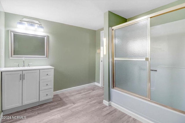 bathroom featuring vanity, shower / bath combination with glass door, and hardwood / wood-style flooring