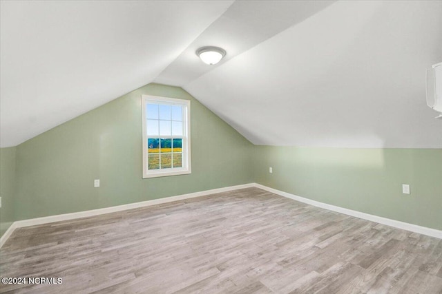 bonus room featuring vaulted ceiling and light wood-type flooring