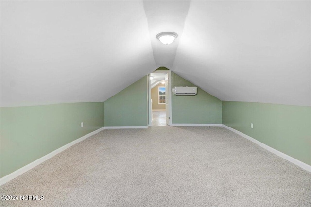 bonus room with carpet, a wall mounted AC, and lofted ceiling