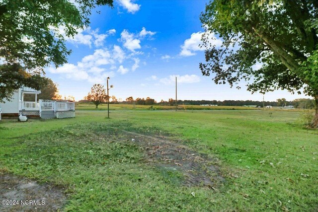 view of yard featuring a deck and a rural view