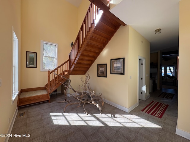 tiled entrance foyer featuring a high ceiling