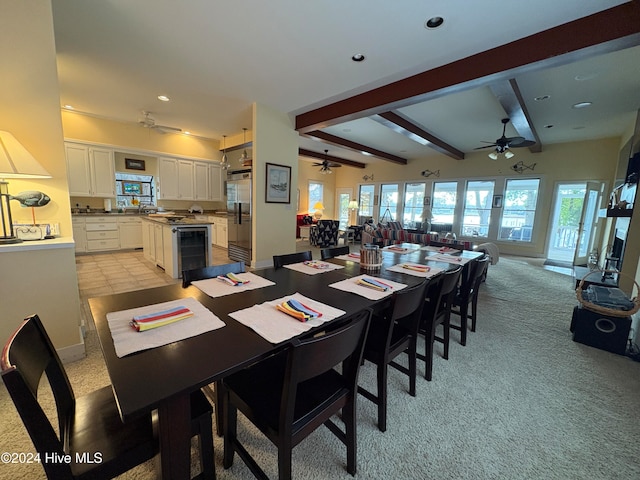 carpeted dining space featuring vaulted ceiling with beams