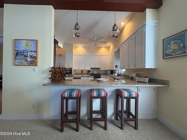 kitchen featuring ceiling fan, white cabinetry, pendant lighting, and kitchen peninsula