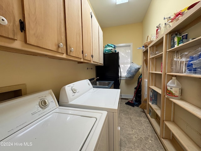 washroom with washing machine and dryer, cabinets, and sink