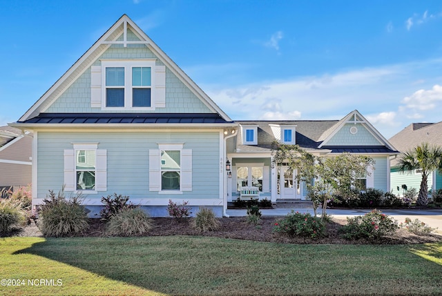 view of front of property with covered porch and a front yard