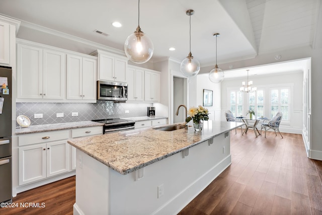 kitchen featuring white cabinetry, sink, pendant lighting, and stainless steel appliances