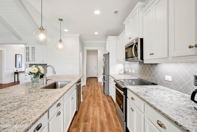 kitchen with light hardwood / wood-style flooring, stainless steel appliances, sink, white cabinets, and light stone counters