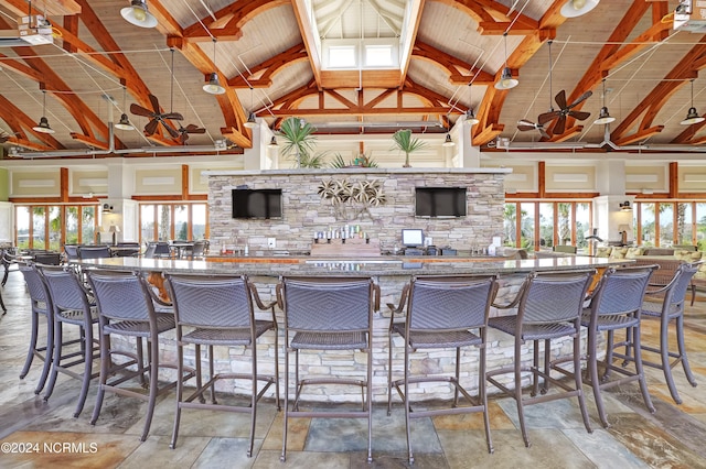 kitchen featuring beam ceiling, wood ceiling, and high vaulted ceiling