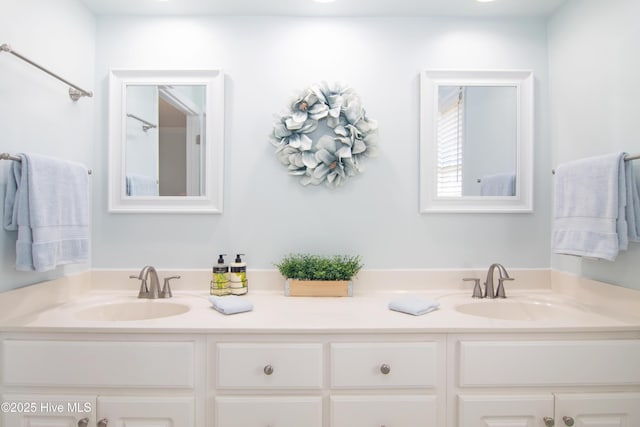 bathroom with double vanity and a sink