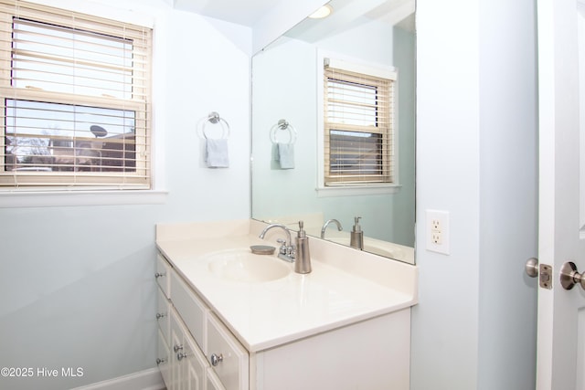 bathroom with vanity and baseboards