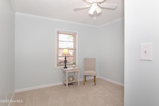 sitting room with crown molding, carpet, and baseboards