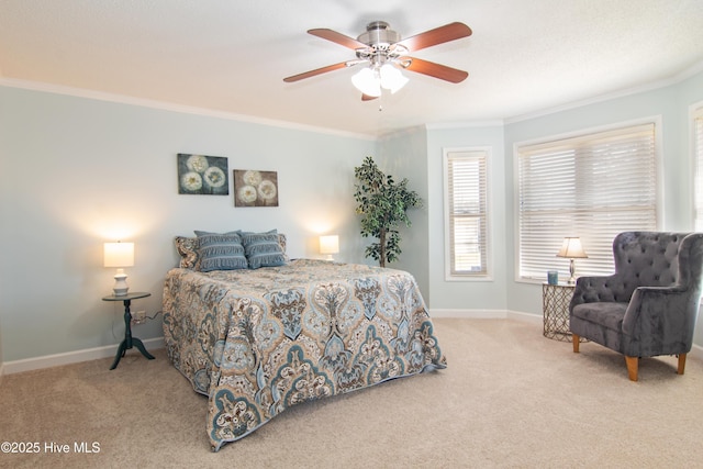 carpeted bedroom featuring ceiling fan, baseboards, and ornamental molding