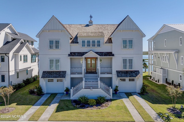 view of front of property with a front yard and a garage