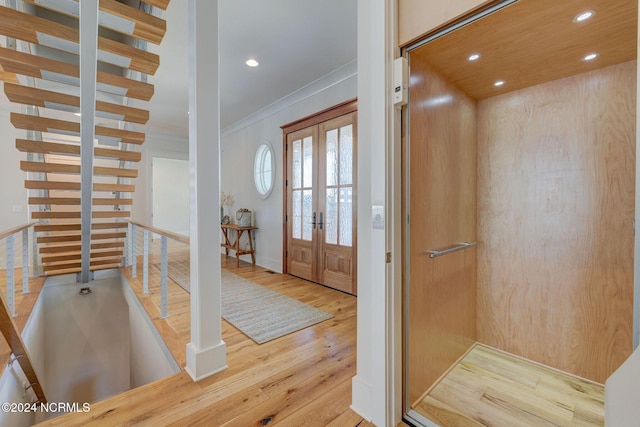7 S Waterfront Pl, Hampstead, NC 28443 - entryway featuring crown molding, wood-type flooring, elevator, french doors, and recessed lighting