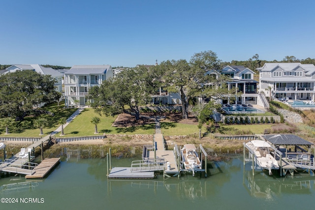 dock area with a water view and a balcony