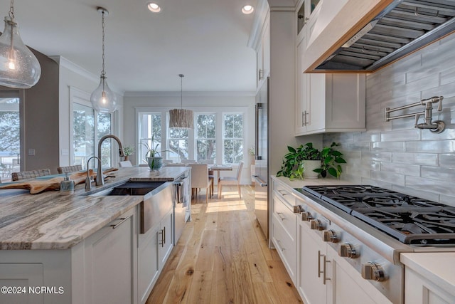 7 S Waterfront Pl, Hampstead, NC 28443 - kitchen with ornamental molding, pendant lighting, white cabinets, and extractor fan
