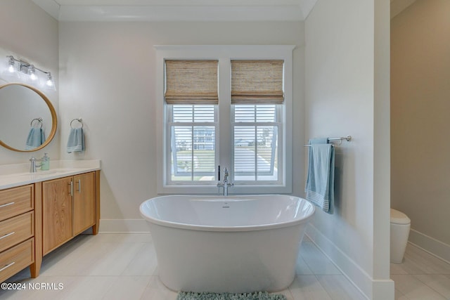 7 S Waterfront Pl, Hampstead, NC 28443 - bathroom featuring vanity, tile patterned flooring, toilet, baseboards, and a soaking tub