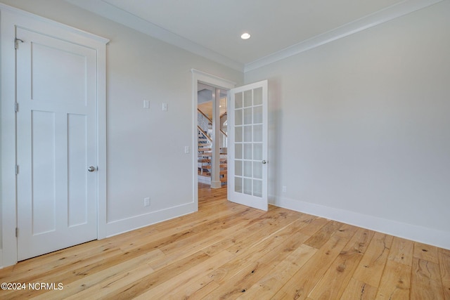 7 S Waterfront Pl, Hampstead, NC 28443 - unfurnished bedroom featuring french doors, wood-type flooring, crown molding, and baseboards