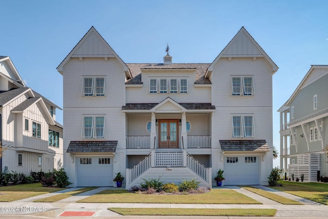 7 S Waterfront Pl, Hampstead, NC 28443 - view of front facade with a garage, french doors, a porch, driveway, and stairway