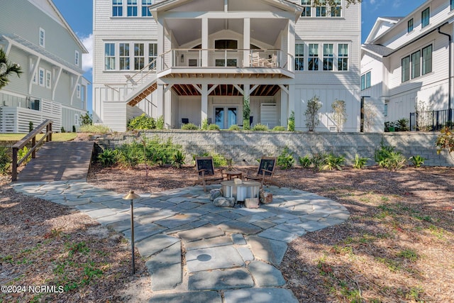 7 S Waterfront Pl, Hampstead, NC 28443 - back of property with a patio, board and batten siding, and stairs