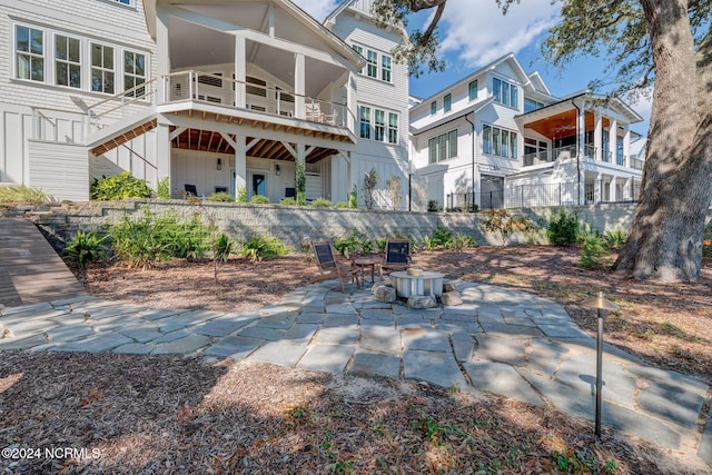 7 S Waterfront Pl, Hampstead, NC 28443 - rear view of house featuring a patio, board and batten siding, and stairway