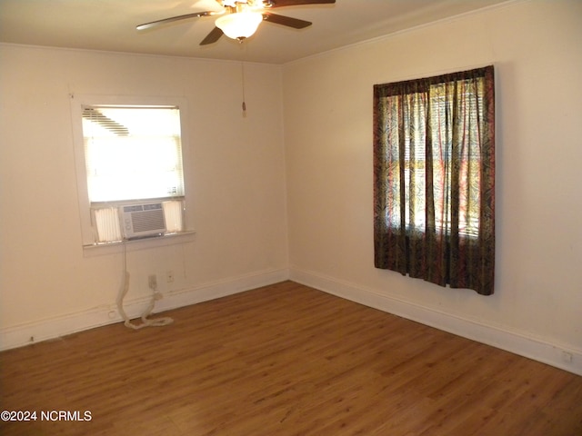 unfurnished room featuring hardwood / wood-style floors, cooling unit, crown molding, and ceiling fan