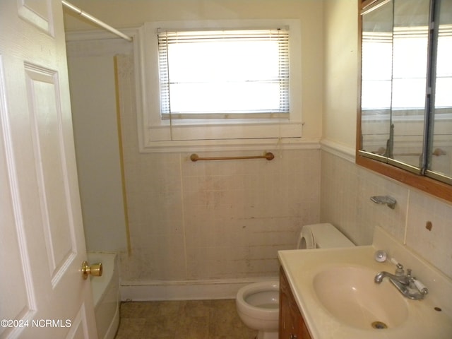 full bathroom featuring toilet, tile walls, shower / tub combination, vanity, and tile patterned flooring