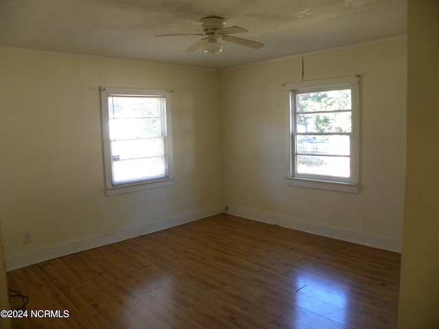 empty room with ceiling fan, wood-type flooring, and ornamental molding