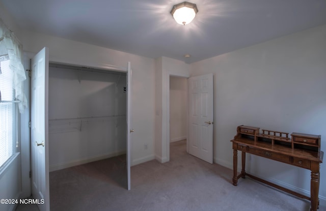 unfurnished bedroom featuring a closet and carpet flooring