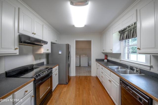 kitchen with sink, washing machine and clothes dryer, white cabinetry, black appliances, and light hardwood / wood-style floors