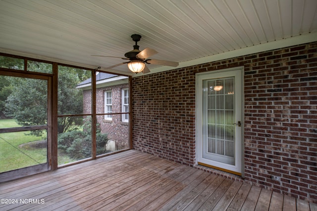 unfurnished sunroom with wooden ceiling and ceiling fan