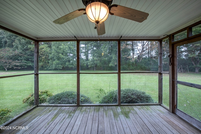 unfurnished sunroom featuring a healthy amount of sunlight and ceiling fan