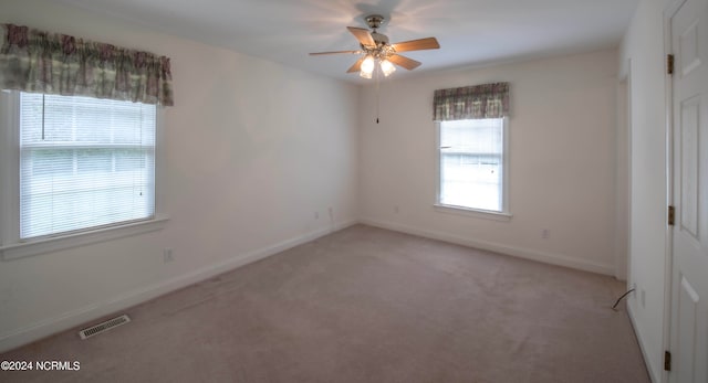 unfurnished bedroom with light carpet and ceiling fan