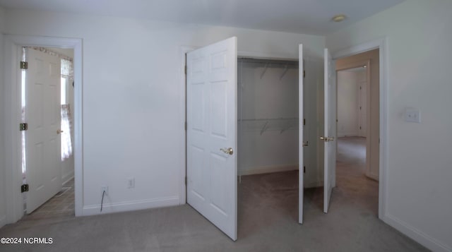 unfurnished bedroom with carpet floors and a closet