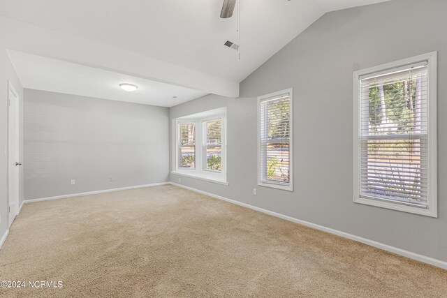 unfurnished room with light carpet, vaulted ceiling, and ceiling fan