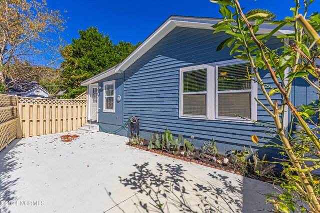 view of side of home with a patio