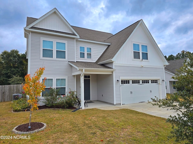 view of front of home featuring a front yard and a garage