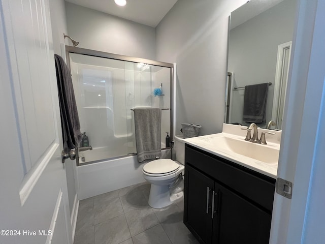 full bathroom with vanity, enclosed tub / shower combo, toilet, and tile patterned floors