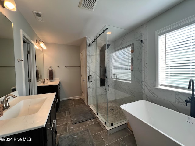 bathroom with vanity, separate shower and tub, and plenty of natural light